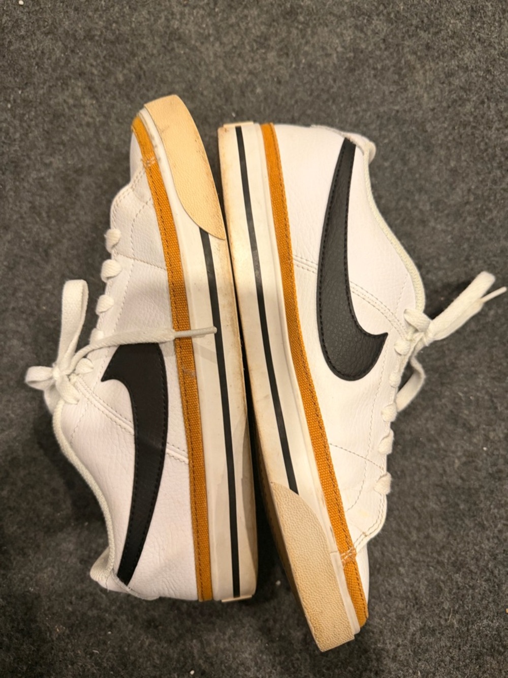 Nike White Sneakers with Black Swoosh and Yellow Stripe